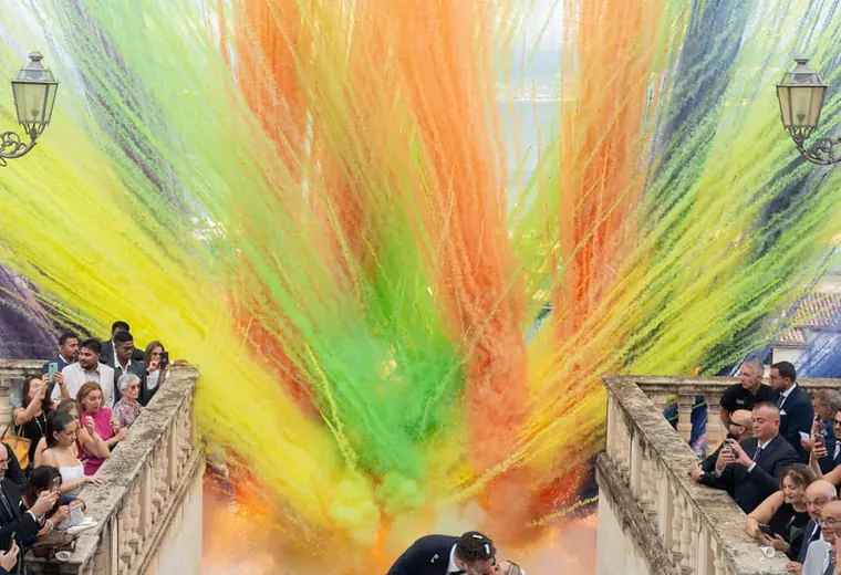 Joyful ceremony exit with colour smoke for a wedding in Italy