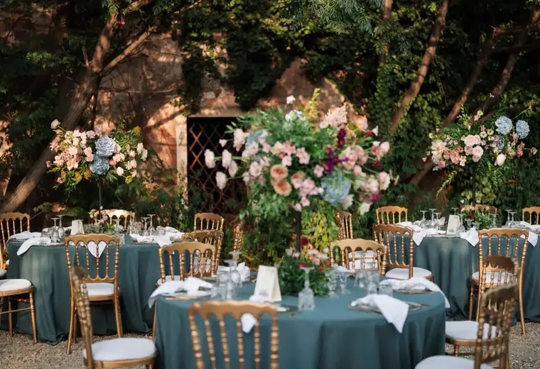 Wedding couple surrounded by lush floral design in Sicily