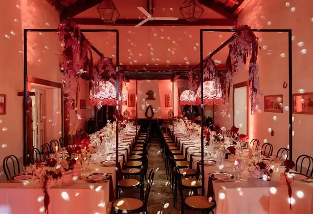 Bride and groom entering a historic Italian ceremony setting with floral design