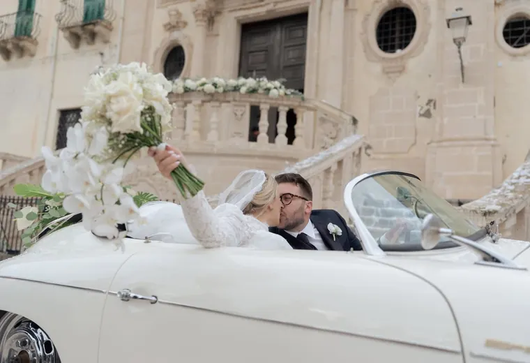 Luxury elopement couple in a vintage wedding car in Sicily